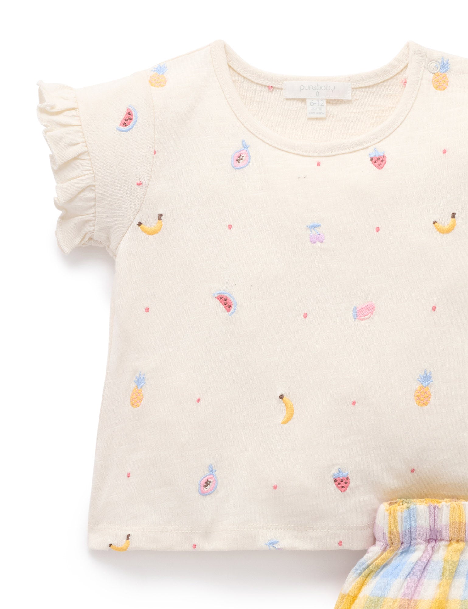 Beige top with fruit patterns on a white background