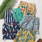 Collection of colorful children's shorts with various patterns on a light background.