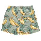 Green shorts with banana and leaf pattern on a white background