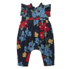 A baby romper with a dark navy blue background and a vibrant floral print featuring blue, red, yellow, and green flowers. The romper has ruffled shoulder straps, a smocked bodice, and a leg opening style typical of baby jumpsuits.
