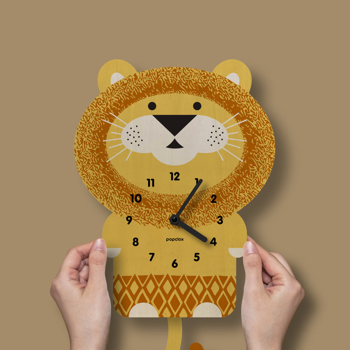 Lion-shaped clock held by hands against a brown background