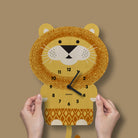 Lion-shaped clock held by hands against a brown background