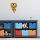 Children's storage unit with colorful bins and toys against a light blue wall.