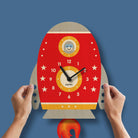 Rocket-shaped clock with a smiley face on a blue background