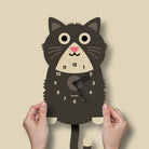 Cat-shaped wall clock with a beige background