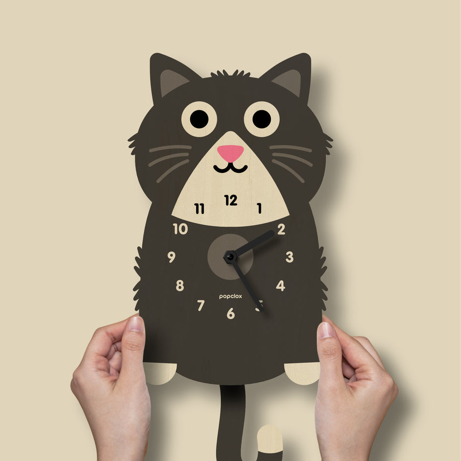 Cat-shaped wall clock with a beige background