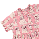 Pink short-sleeve dress with a dog print pattern, featuring illustrations of various dog breeds in cream and brown on a pink background.