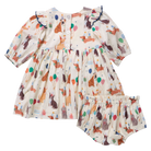 A baby girl's two-piece outfit set consisting of a short-sleeve dress and matching bloomers. The cream-colored fabric features an all-over print of woodland animals like foxes, rabbits, and squirrels, along with colorful balloons and stars.