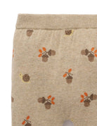 Beige fabric with autumn-themed pattern featuring leaves and acorns on a white background
