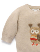Beige sweater with owl design on a white background