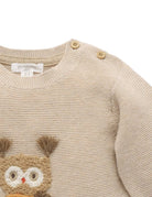 Beige knitted sweater with owl design and 'purebaby' label on a white background