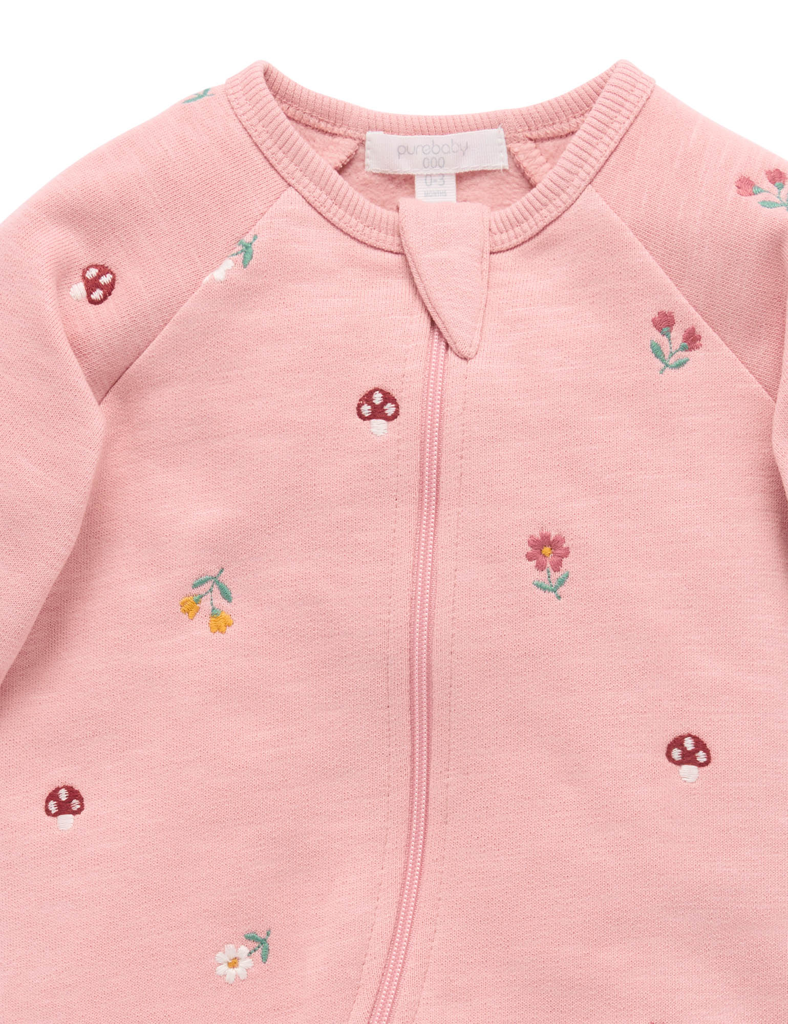 Pink baby jacket with floral embroidery on a white background