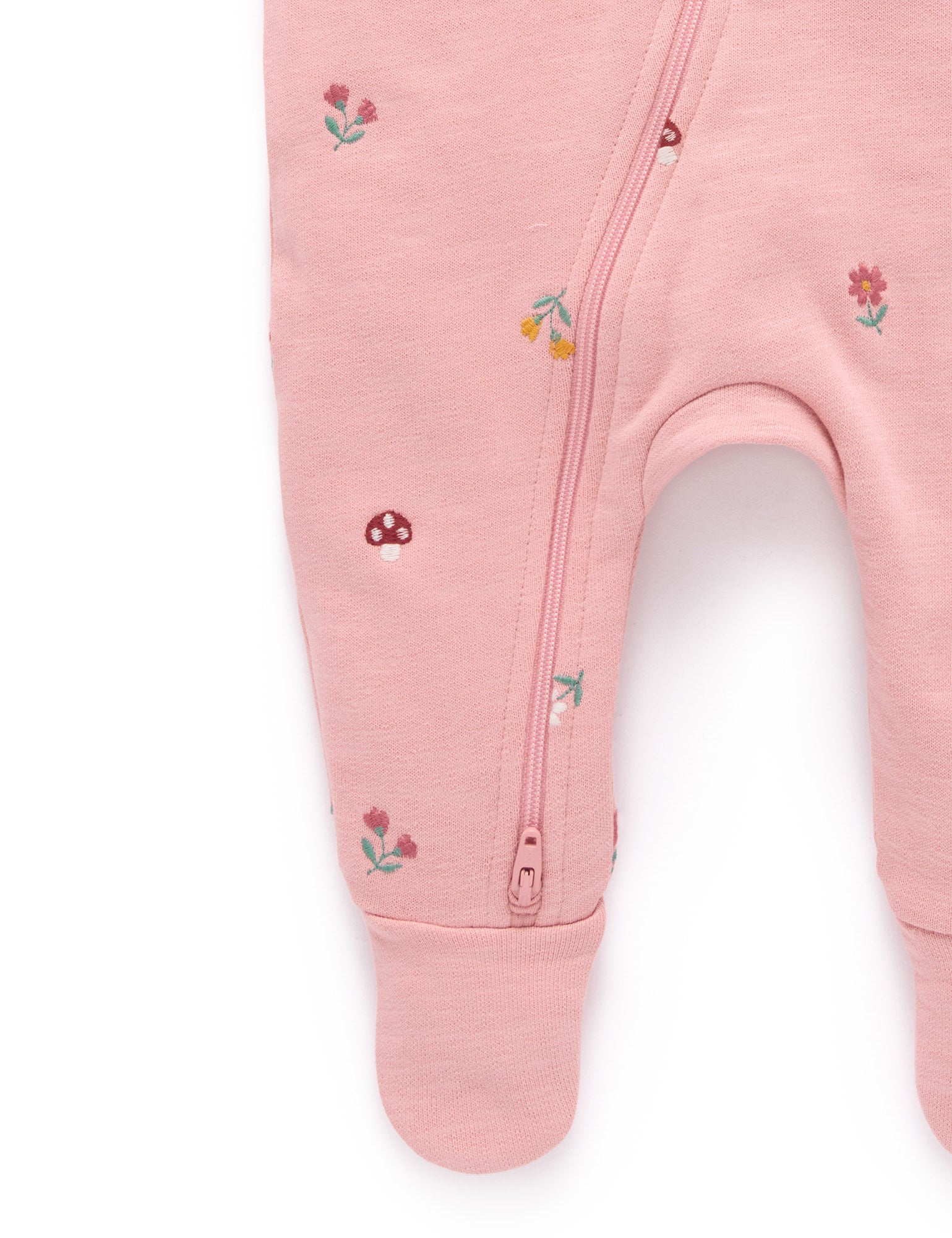 Pink baby onesie with floral embroidery on a white background