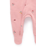 Pink baby onesie with floral embroidery on a white background