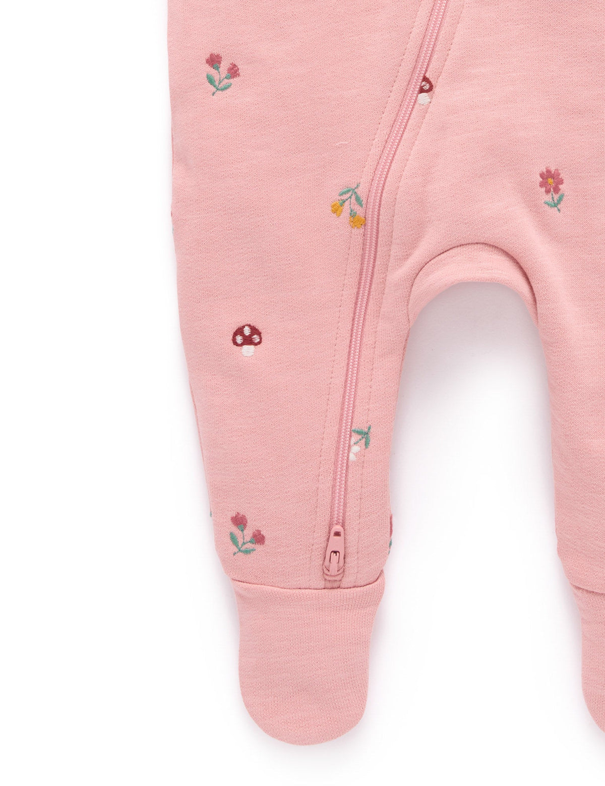 Pink baby onesie with floral embroidery on a white background