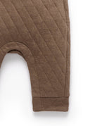 Brown quilted baby romper on a white background