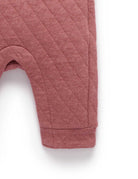 Quilted pink baby pants on a white background