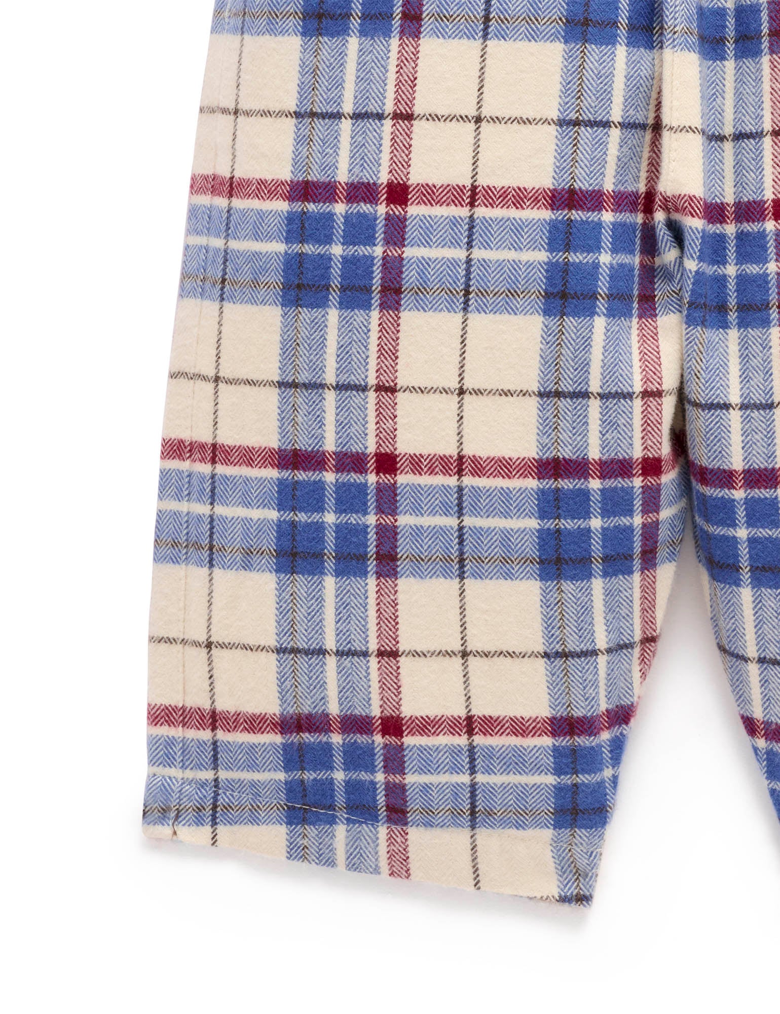 Close-up of a plaid fabric with blue, red, and white colors on a white background