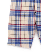 Close-up of a plaid fabric with blue, red, and white colors on a white background