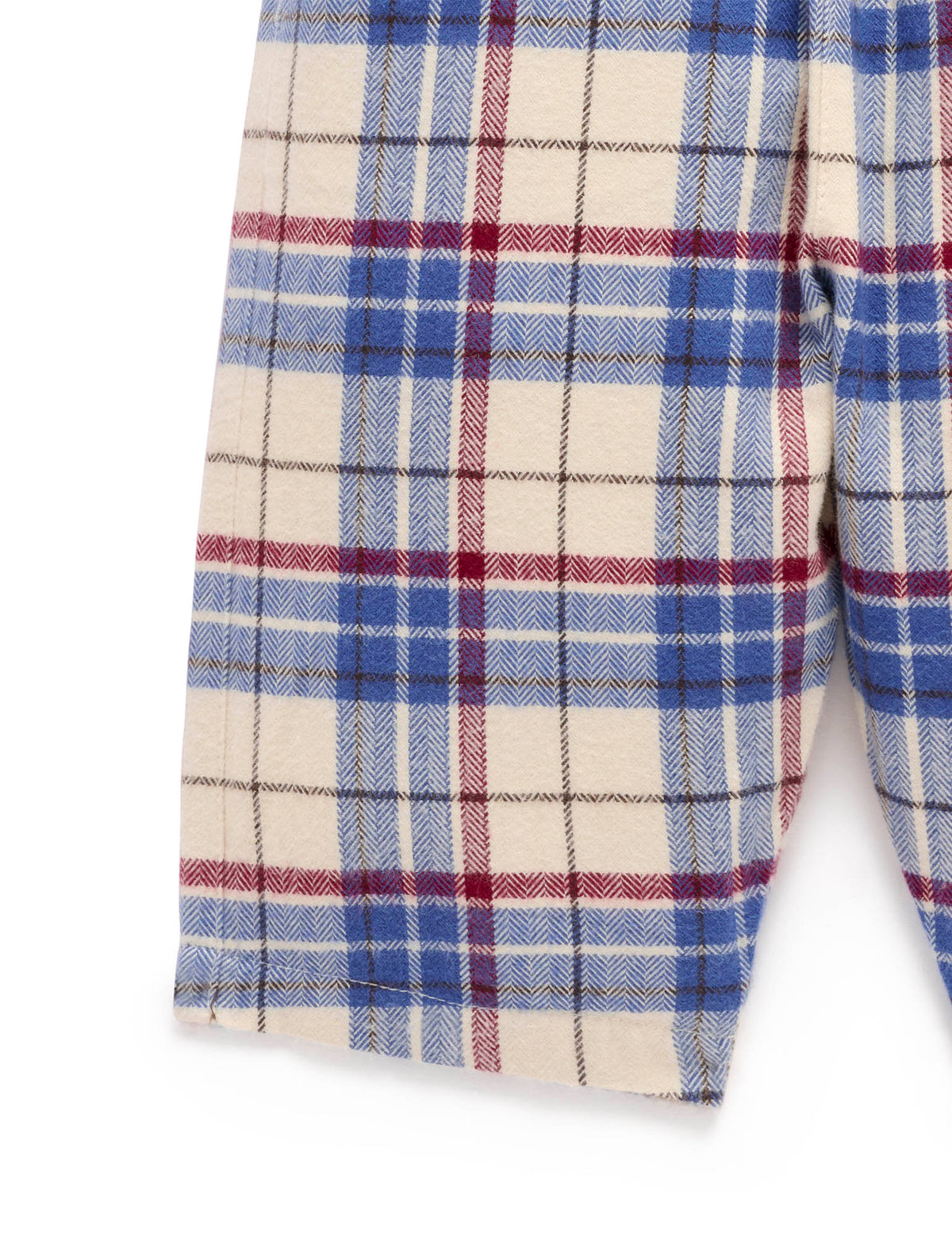 Close-up of a plaid fabric with blue, red, and white colors on a white background