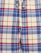 Close-up of a plaid fabric with blue, red, and white colors.