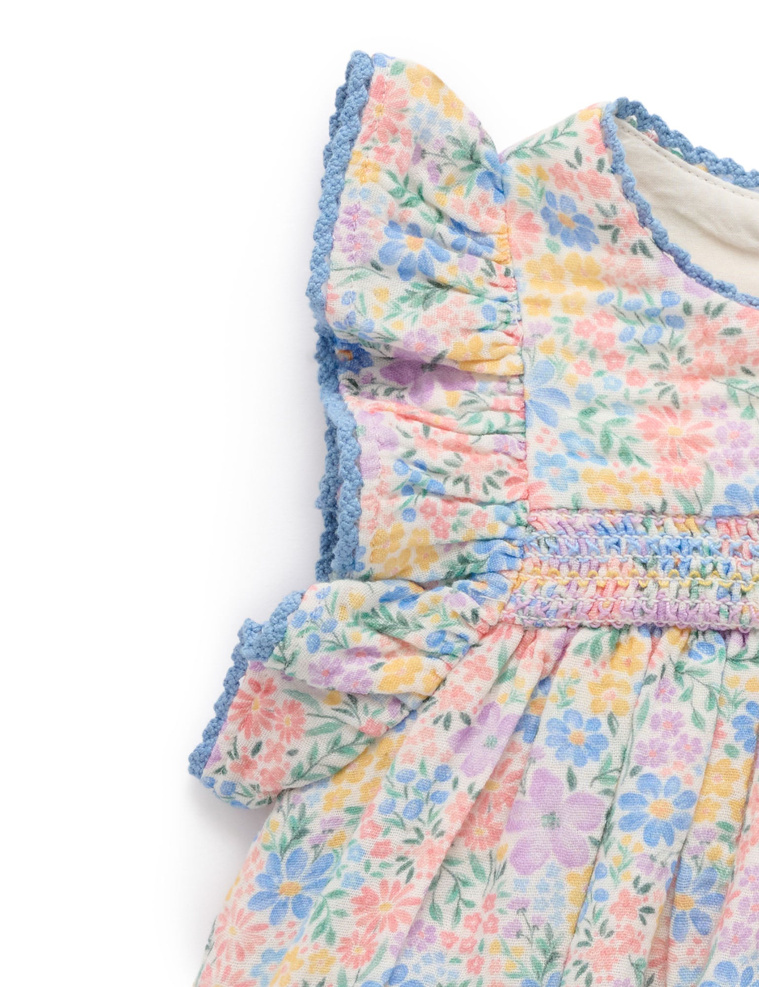 Pastel floral dress with ruffled details on a white background