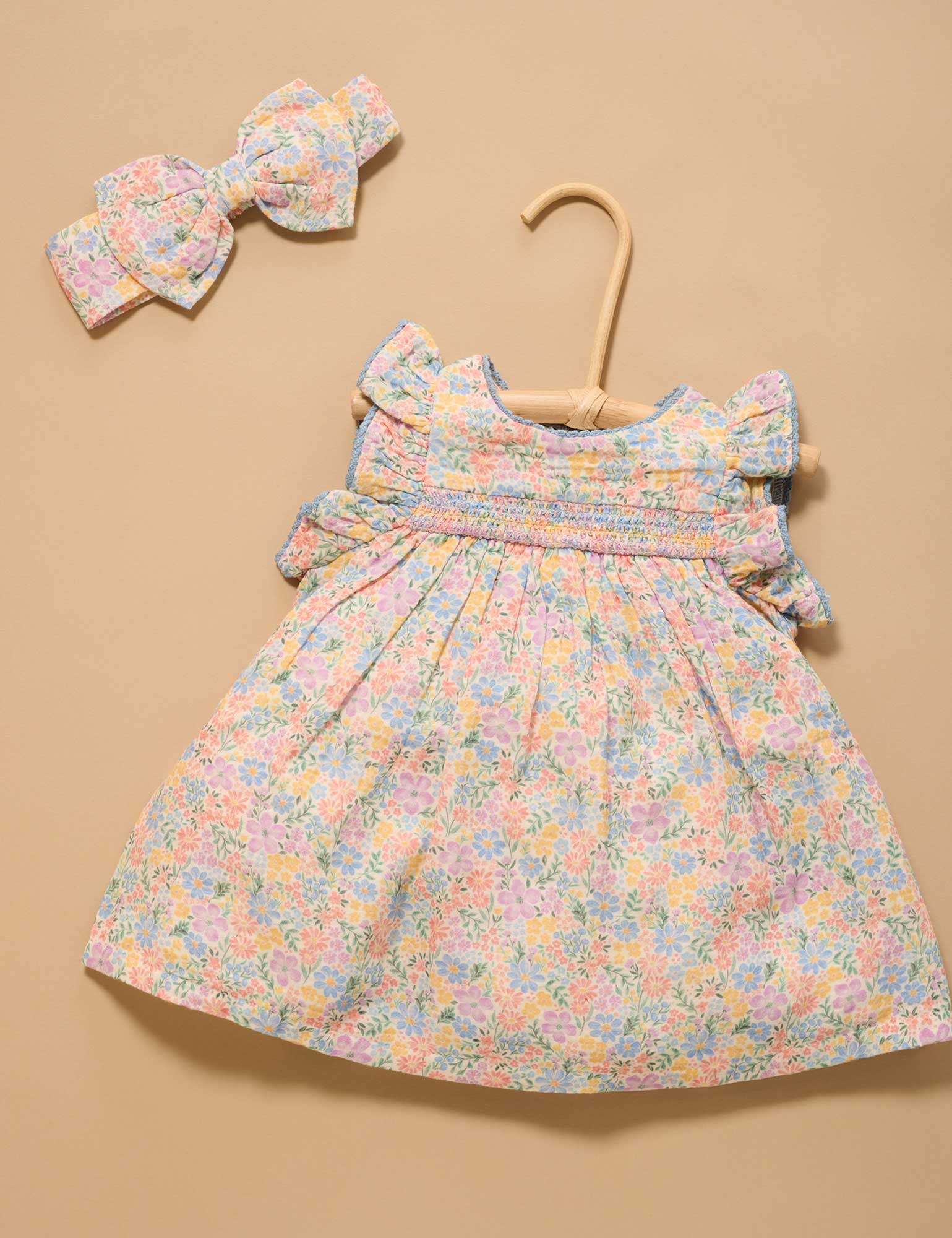 Floral dress with matching headband on a beige background