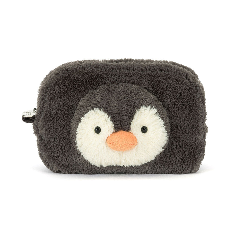 A plush penguin-shaped pouch or cosmetic bag in dark charcoal gray and white with a small orange beak, photographed on a clean white background.
