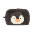 A plush penguin-shaped pouch or cosmetic bag in dark charcoal gray and white with a small orange beak, photographed on a clean white background.