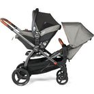 Gray and black stroller with a baby seat on a white background