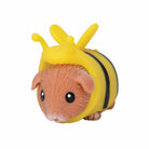 Small animal figurine wearing a yellow, black costume with wings and horn on a white background