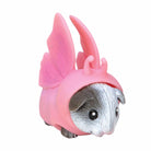 Small animal figurine wearing a pink costume with wings and horn on a white background