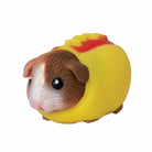 Toy figure of a guinea pig in a yellow car with red interior on a white background
