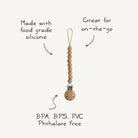 Wooden pacifier clip with text highlighting features on a white background