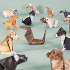 Collection of origami animals on a light green background