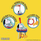 Snoopy-themed teething toy set with instructions on a yellow background, featuring the Peanuts brand.