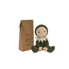 Stuffed toy with packaging on a green background