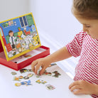 Child playing with a puzzle set on a white surface