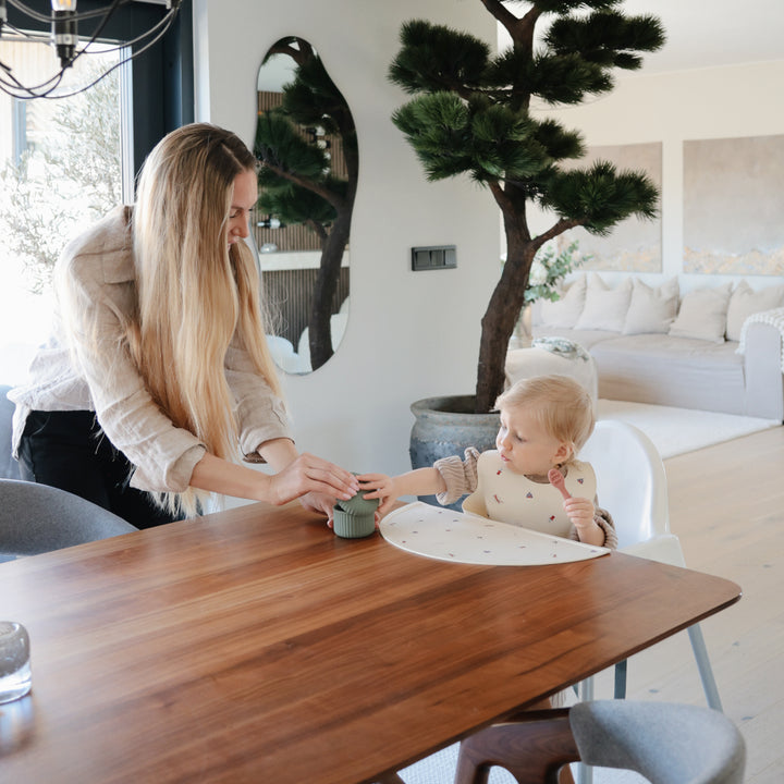 Woman and child at a dining table in a modern living room