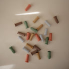 Colorful cylindrical objects scattered on a beige surface