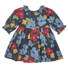 A toddler girl's long-sleeve dress with a dark navy blue background and a colorful floral print featuring light blue, red, yellow, and green flowers. The dress has a buttoned neckline, ruffled collar, and a gathered skirt.