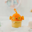 Orange and yellow plush toy with a happy face on a white background