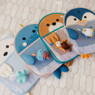 Set of bath toys with animal designs on a tiled floor