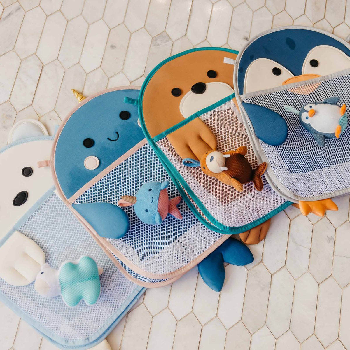 Set of bath toys with animal designs on a tiled floor