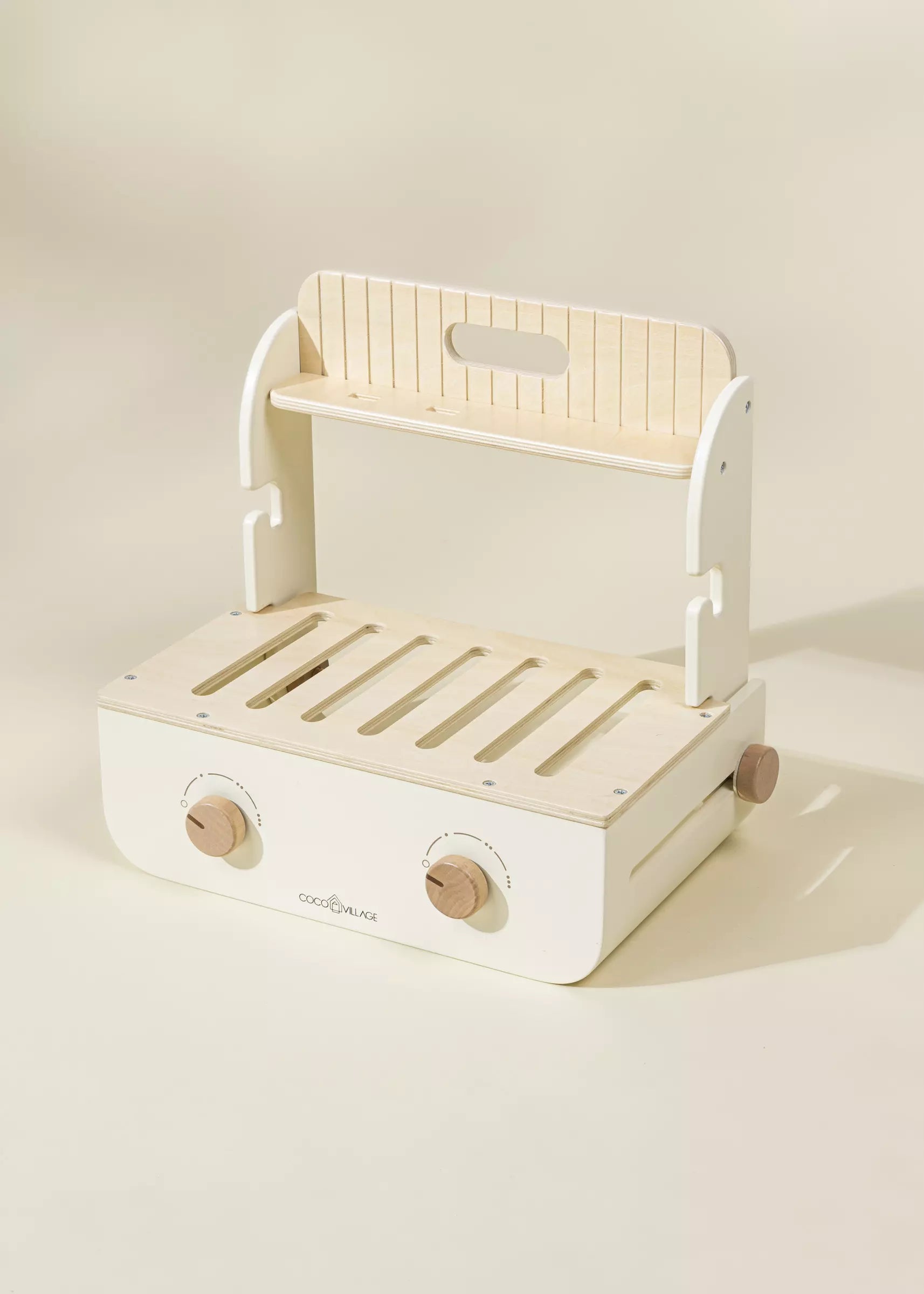 White and beige toy kitchen cart with wooden accents on a light background