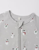 A close-up view of the upper chest and collar area of a light grey Quincy Mae bamboo zip footie, featuring an all-over wintery snowman print and a central zipper.