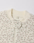 Close-up of  Quincy Mae Zip Long Sleeve Sleeper Footie in the "French Garden" print on an ivory background