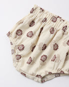 Cream-colored cotton diaper cover with a brown and beige floral pattern, featuring an elastic waistband.