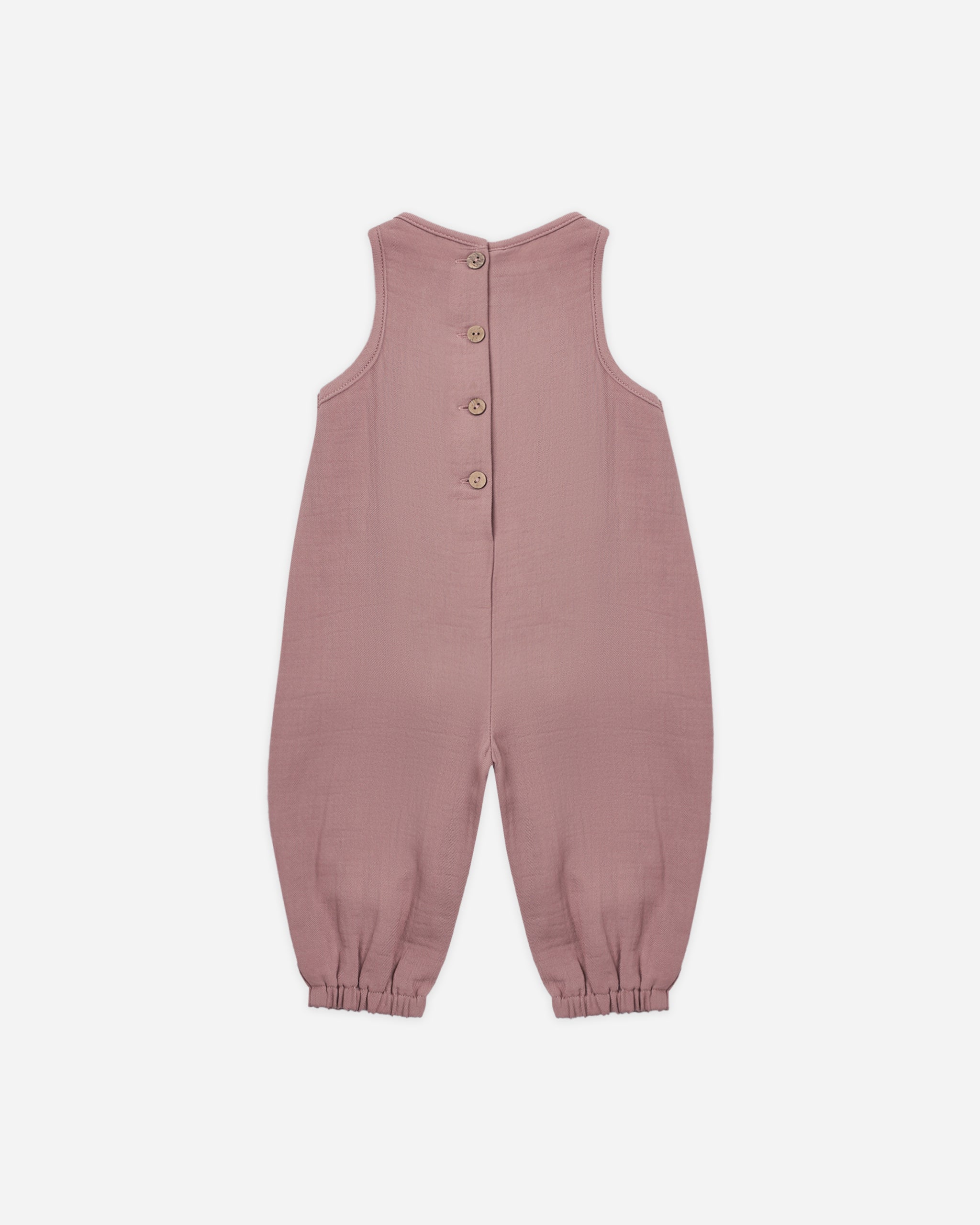 A sleeveless dusty rose baby jumpsuit with a button-up back, photographed flat against a light gray background.