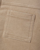 Close-up detail of the front patch pocket on the Ezrah Jacket in latte corduroy by Quincy Mae.